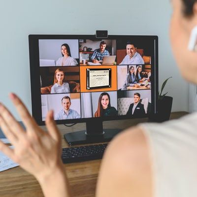 Zoom meeting with team members and rectangle acrylic award in center of screen.